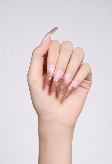 Pink and brown ombre coffin nails with a glossy finish, white star accents, and a dreamy Y2K nail design for a cute, elegant look.