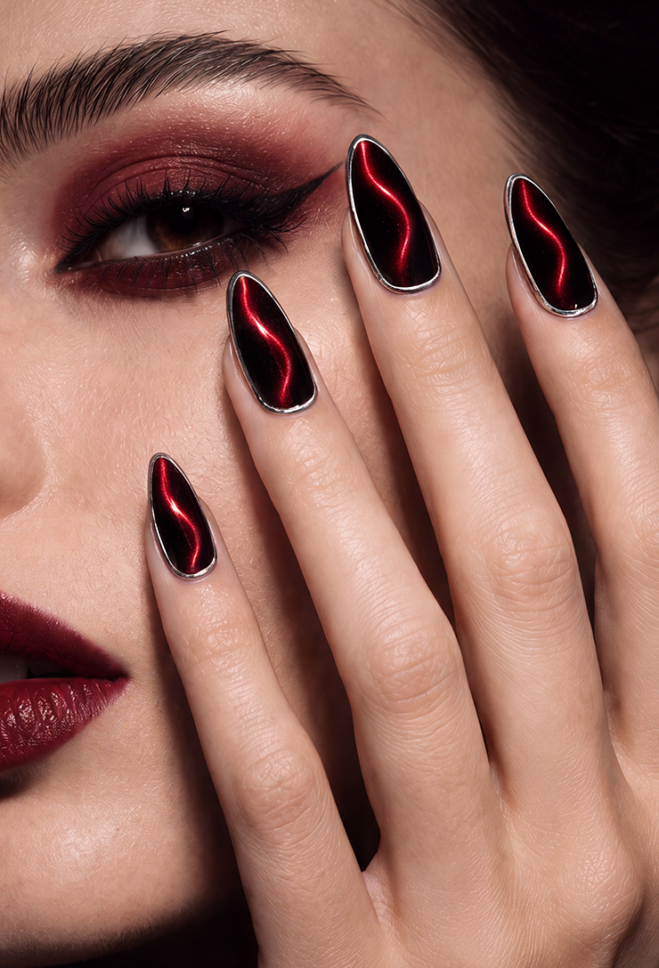 Almond nails featuring a mysterious red-and-black cat-eye effect and metallic silver edges create a stylish "Blood Moon" look, perfectly embodying a bold and mysterious Gothic aesthetic.
