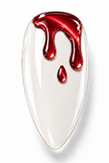 Applying a glossy top coat over ivory and red drip nails to seal the design