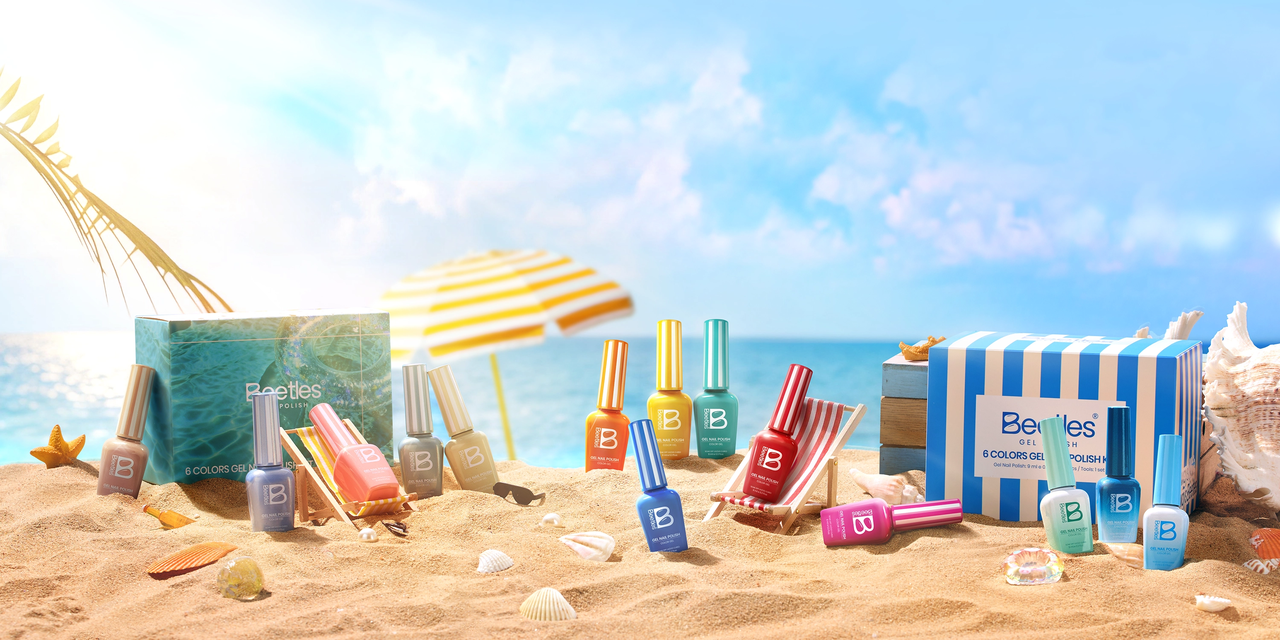 Beetles gel nail polish kits displayed on mini beach loungers on a sandy beach with turquoise ocean, seashells, and palm fronds — summer vacation lifestyle flat lay