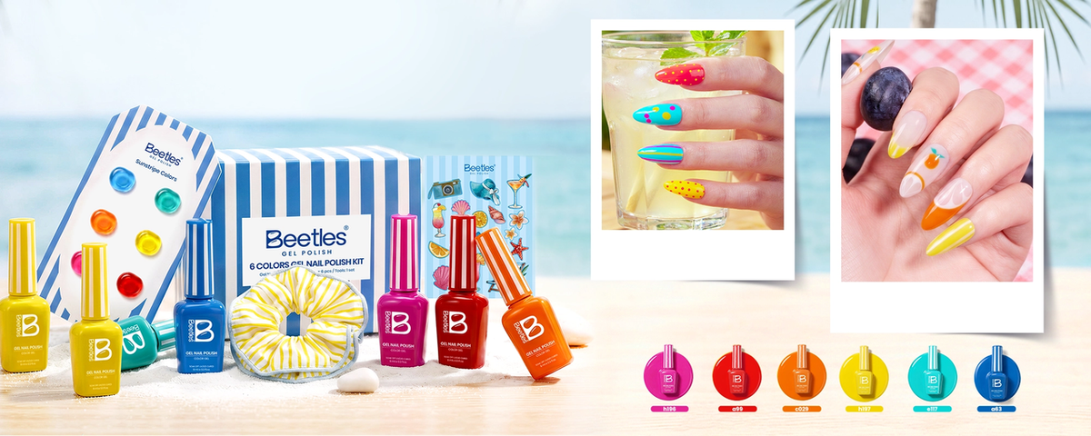 Beetles Sunstripe 6-color gel nail polish kit in blue-and-white striped box with nail swatches, themed stickers, and beach-inspired nail art on sandy surface