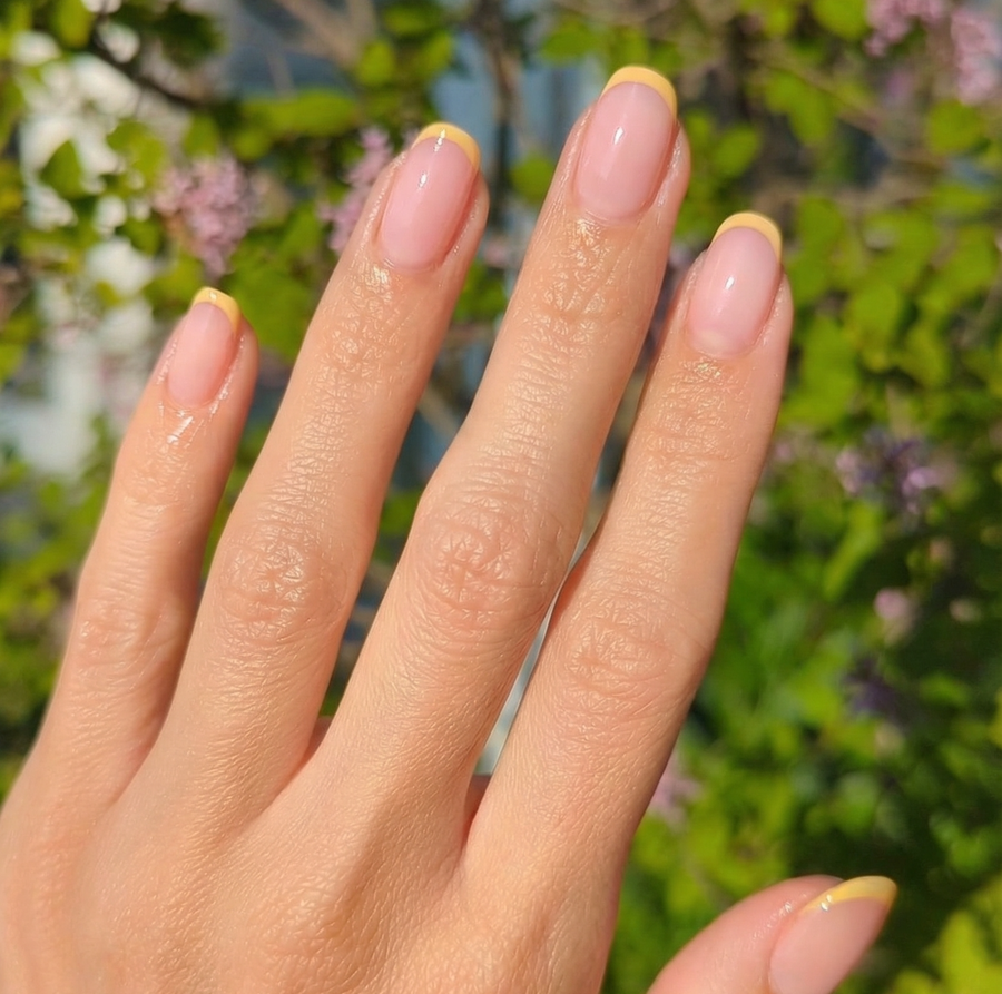 Nude jelly nails with bright yellow French manicure