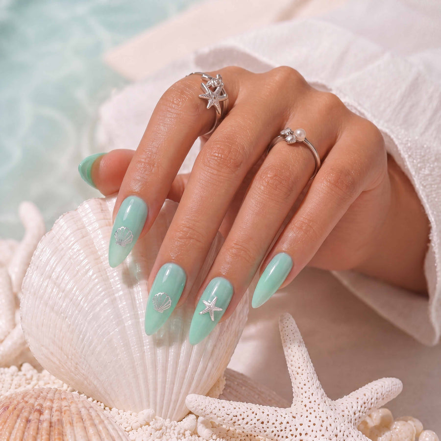 mint green nails with semi transparent finish and subtle silver accents